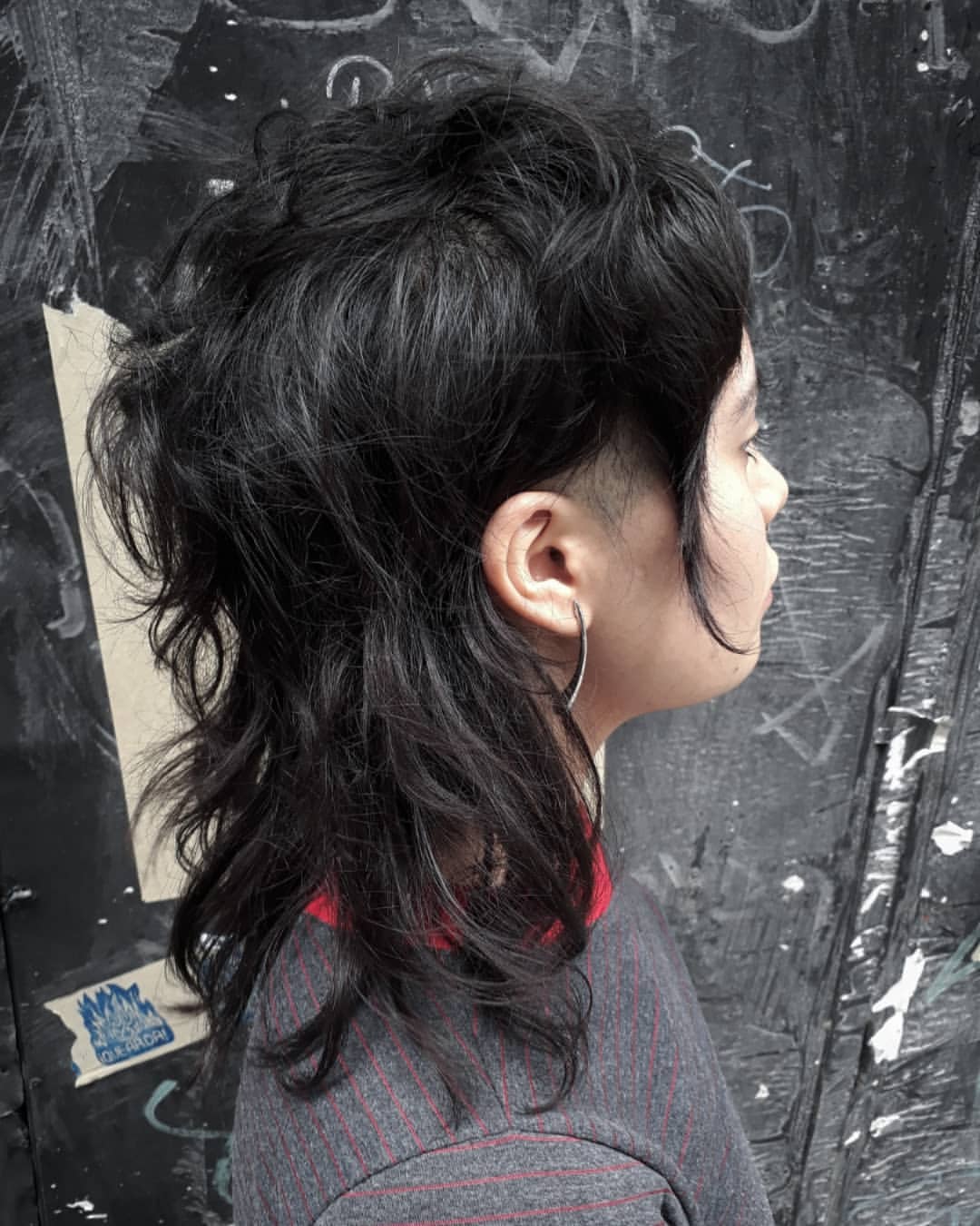 10. Textured Black Shaggy Mullet with Undercut Sides