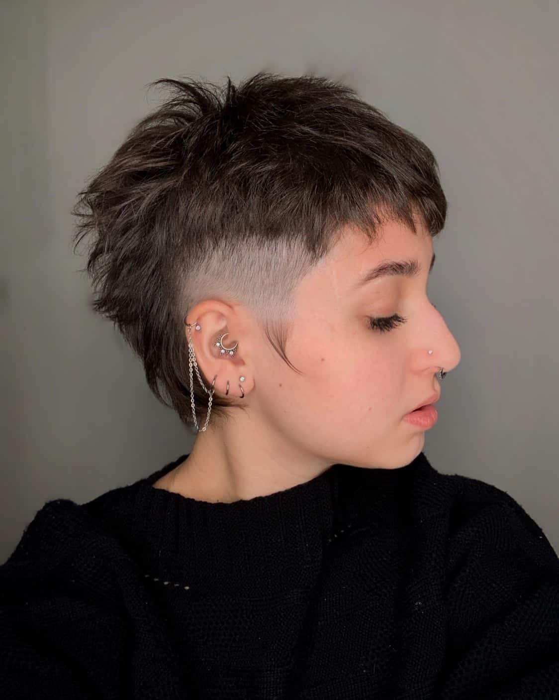 21. Textured Mullet with Shaved Sides and Baby Bangs