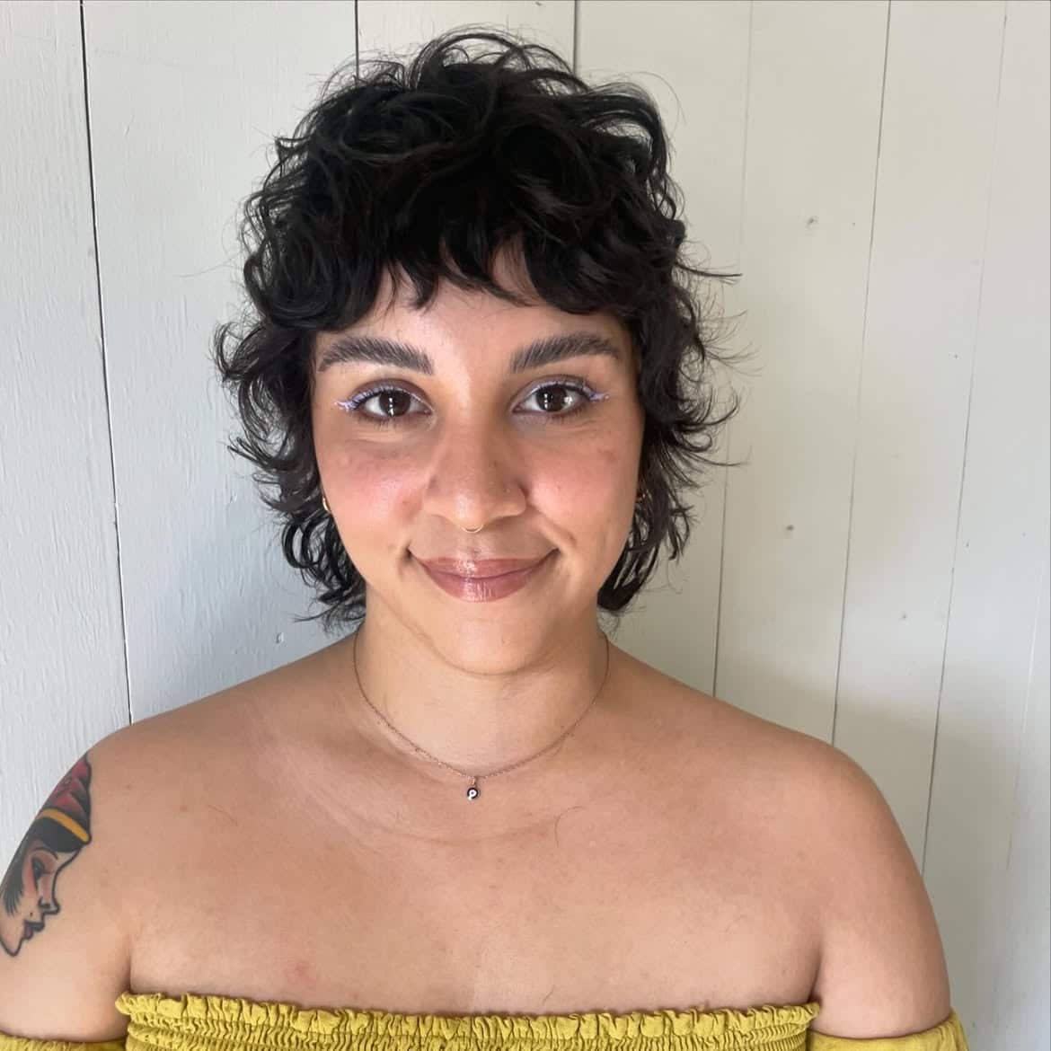 41. Tousled Black Pixie Mullet with Micro Bangs