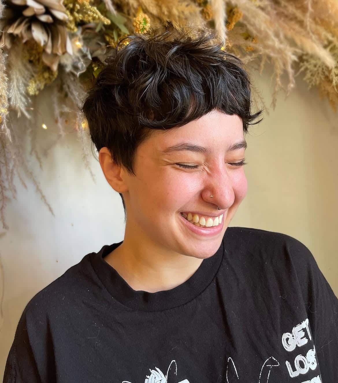 46. Tousled Brunette Pixie Mullet with Baby Bangs