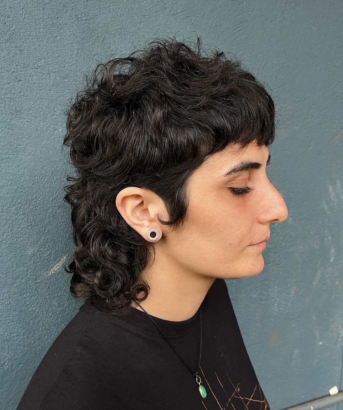 49. Tousled Dark Curls with Short Bangs