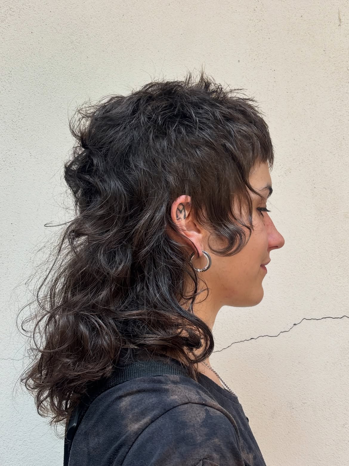 48. Tousled Dark Shag Mullet With Baby Bangs