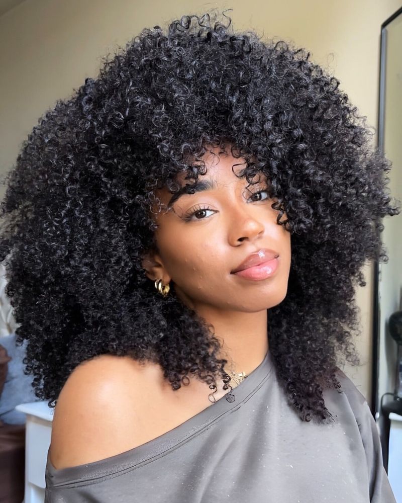 40. Voluminous Curly Shag with Full Bangs