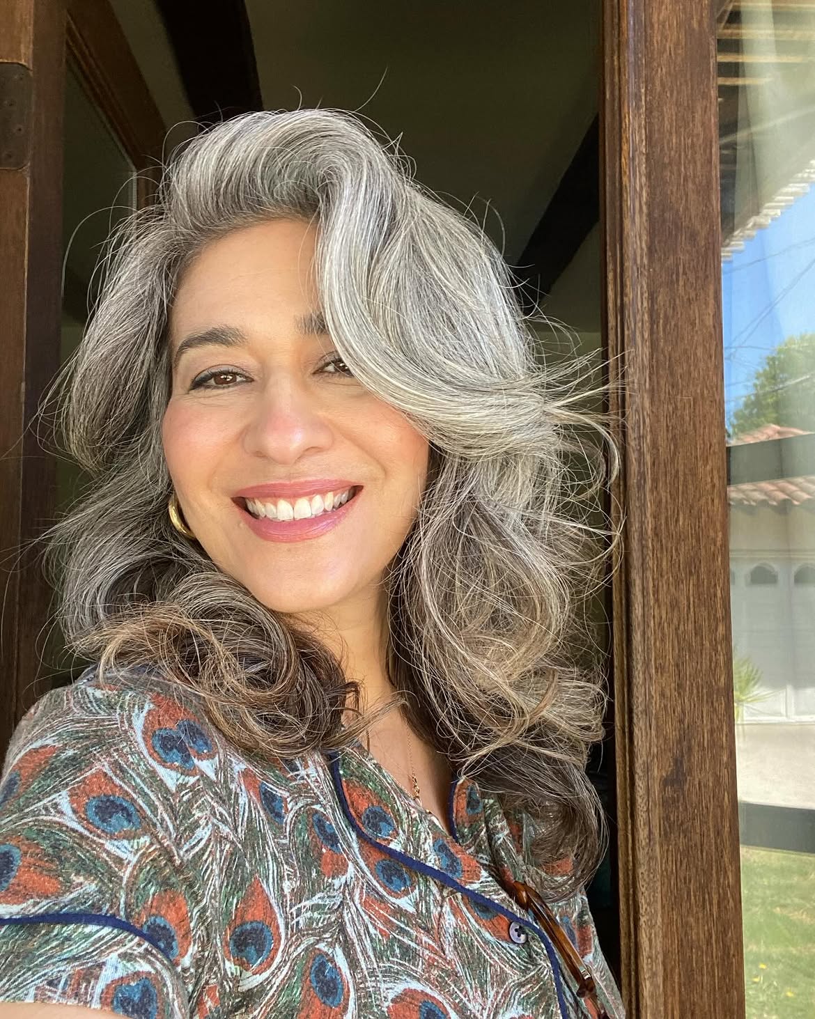 9. Voluminous Silver Grombre Layers with a Swept Side Part