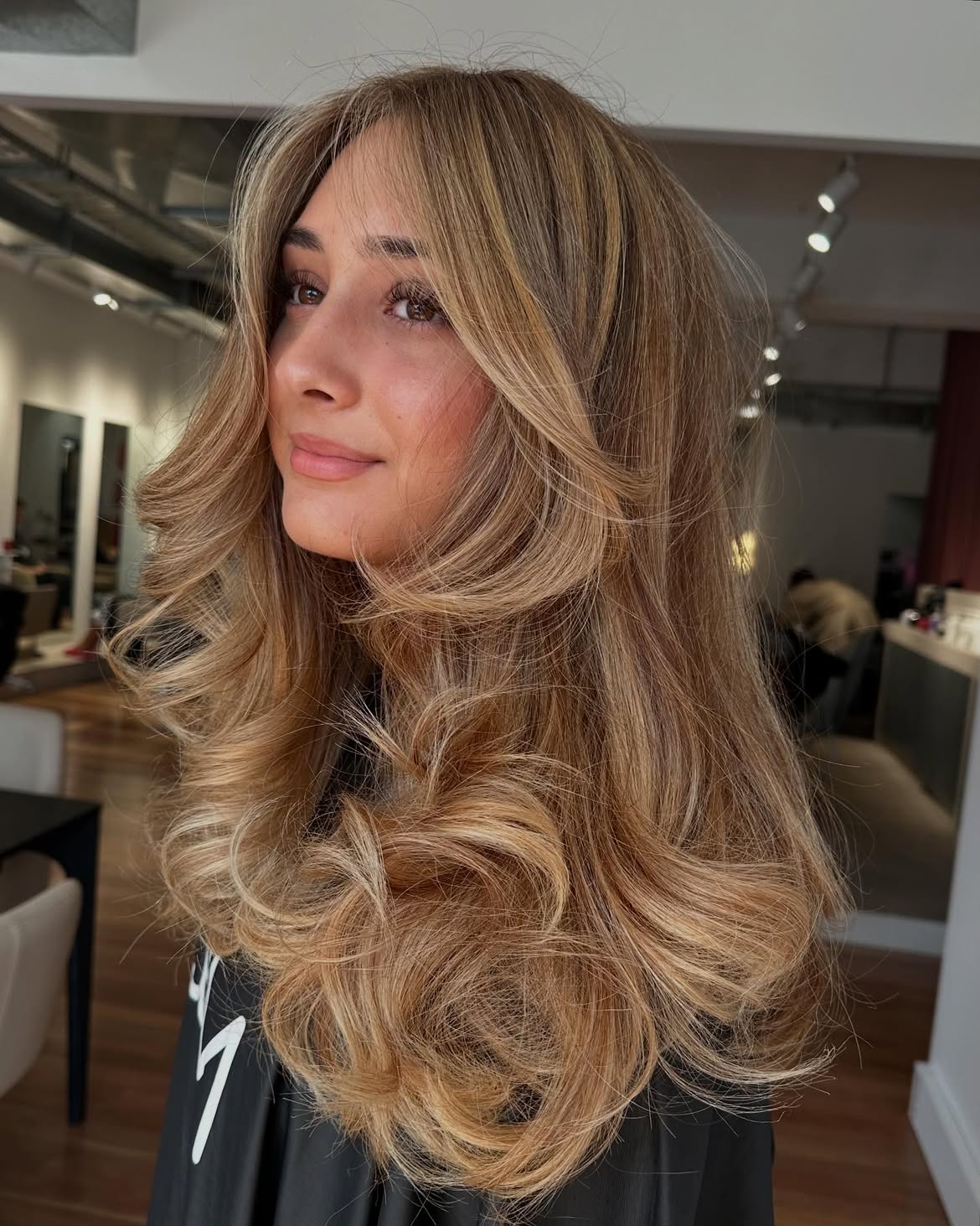 29. Warm Champagne Blowout with Curtain Bangs