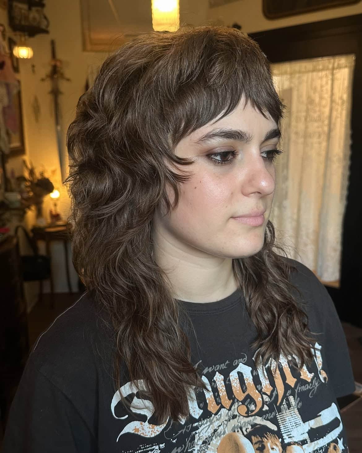 37. Wavy Brunette Shag Mullet with Wispy Baby Bangs