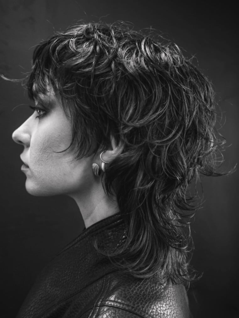 14. Wet-Look Wavy Shag Mullet with Baby Bangs