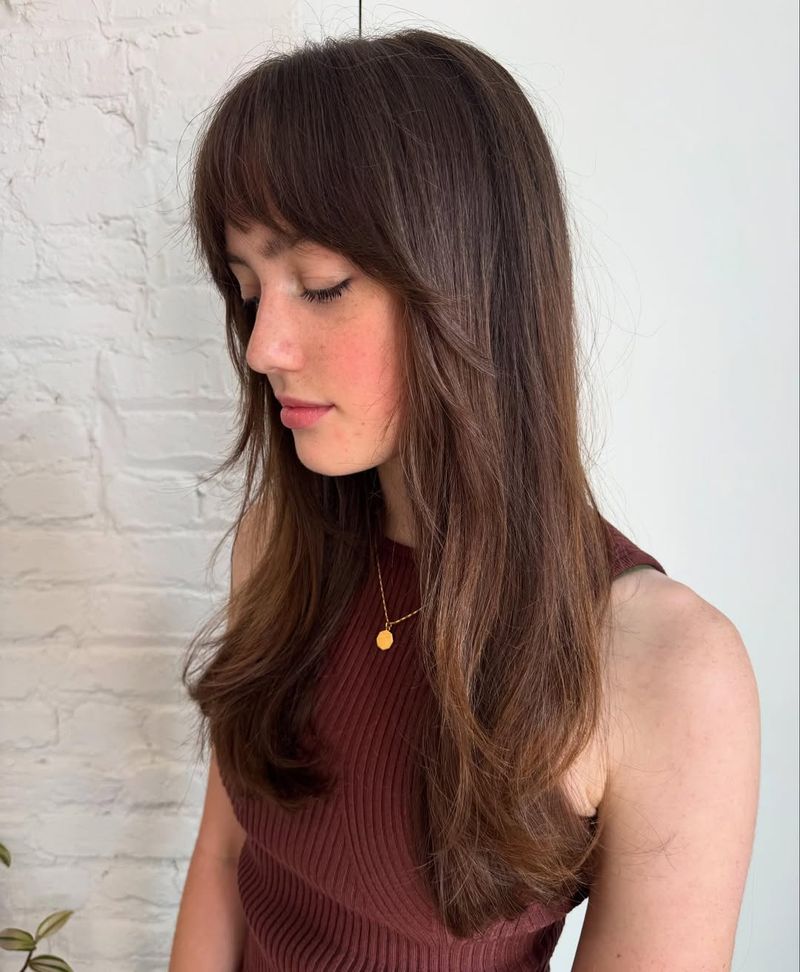 17. 70s-Inspired Soft Layers with Brow-Skimming Fringe
