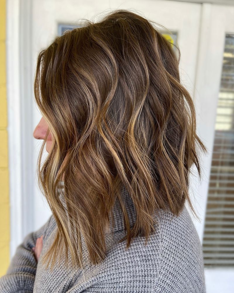 16. Angled Brunette Lob with Caramel Highlights