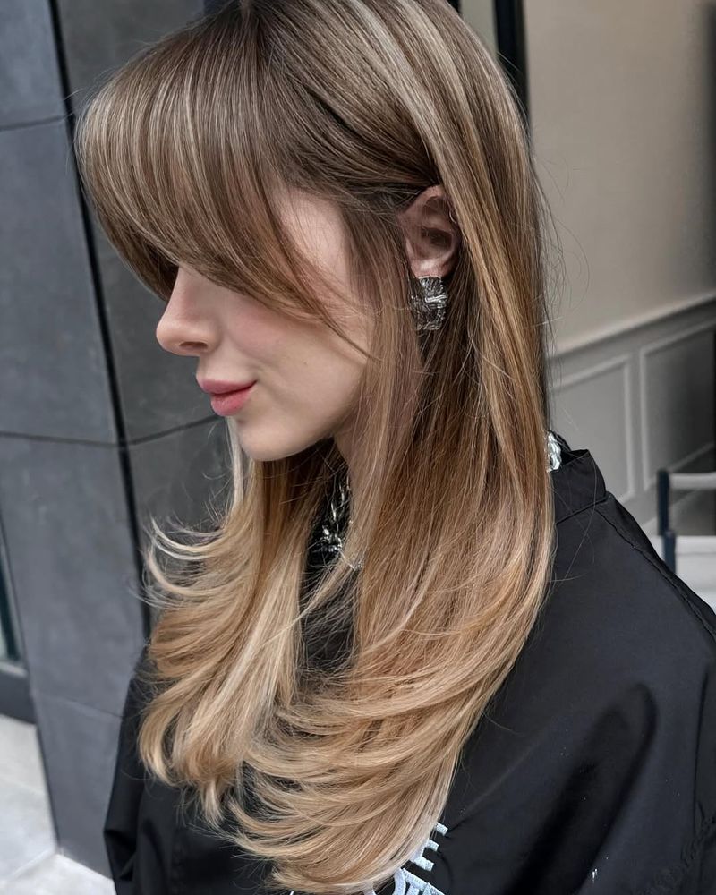 12. Ash Blonde Layers with Sweeping Fringe