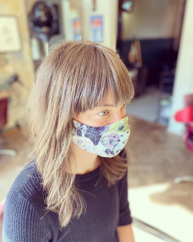 19. Ash Blonde Shag with Heavy Bangs