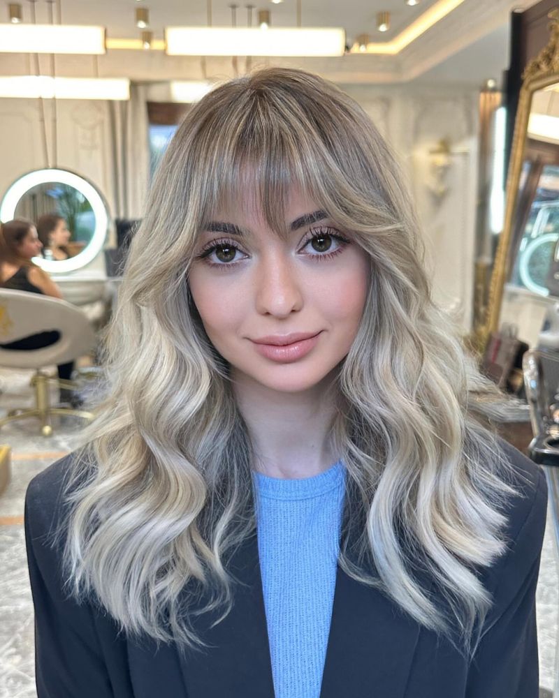 22. Ash Blonde Waves with Soft Fringe