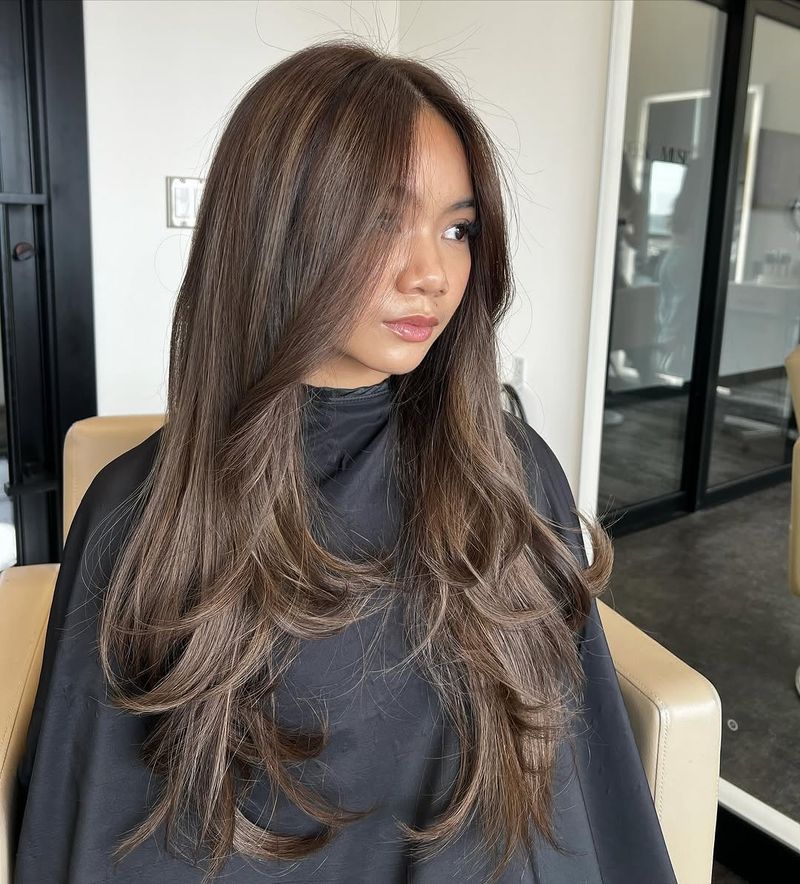 1. Ash-Toned Layers with Face-Framing Curtains