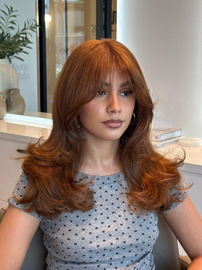 7. Auburn Butterfly Layers with Curtain Bangs
