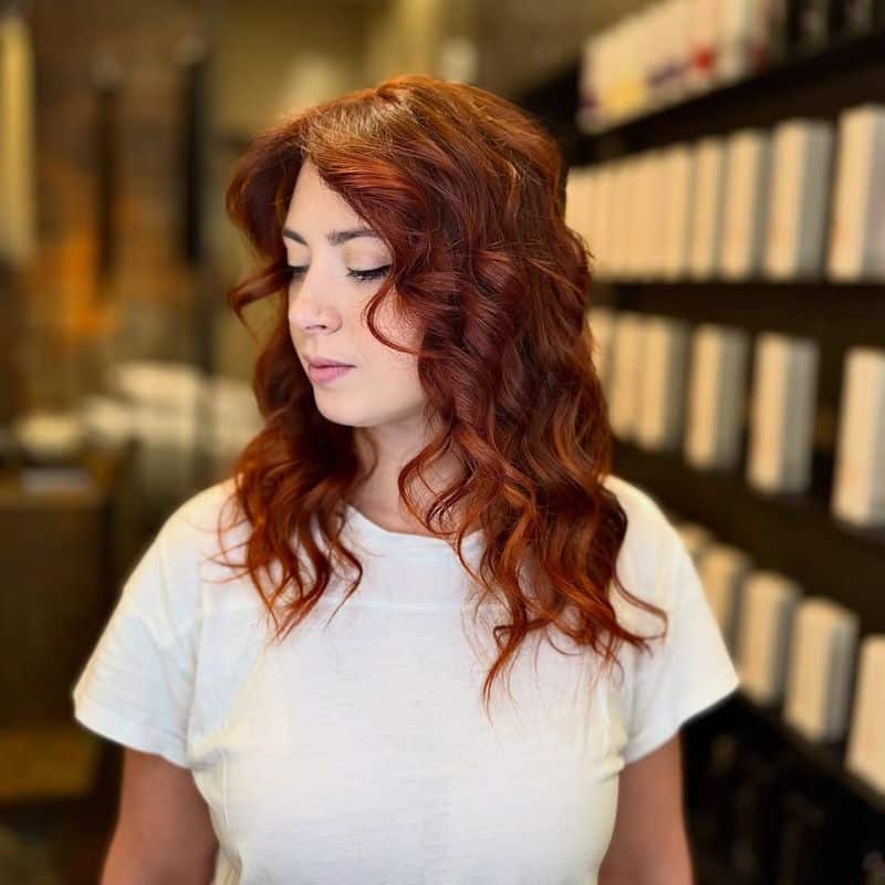 10. Auburn Curls with Curtain Bangs