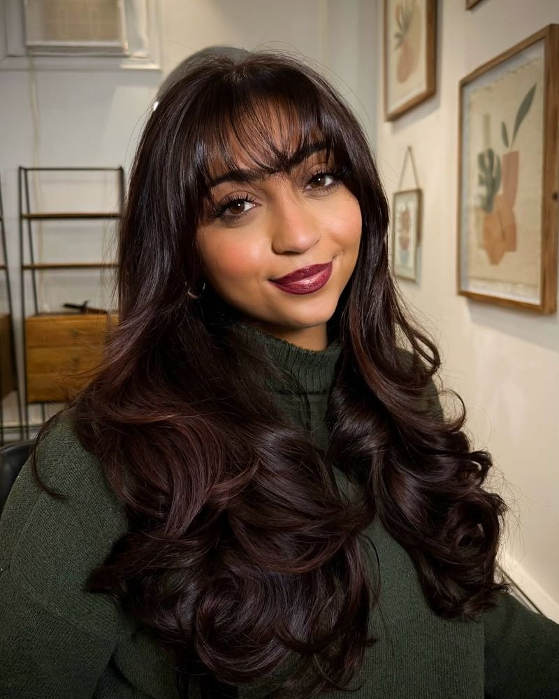 2. Black Cherry Tones with Soft Bangs