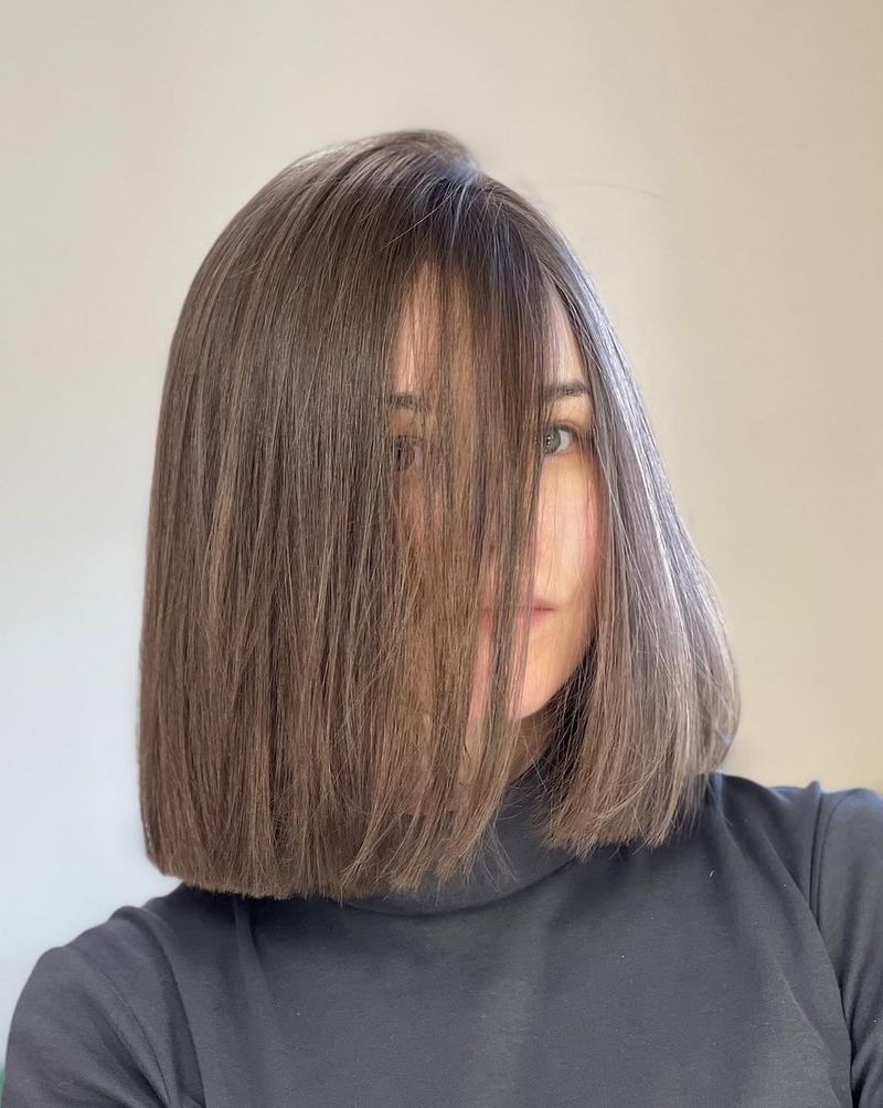 31. Blunt Cut Bob with Face-Skimming Fringe