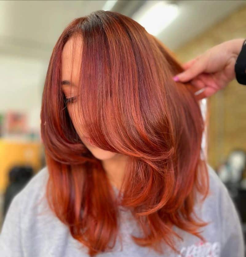11. Bright Penny Layered Cut with Curtain Bangs