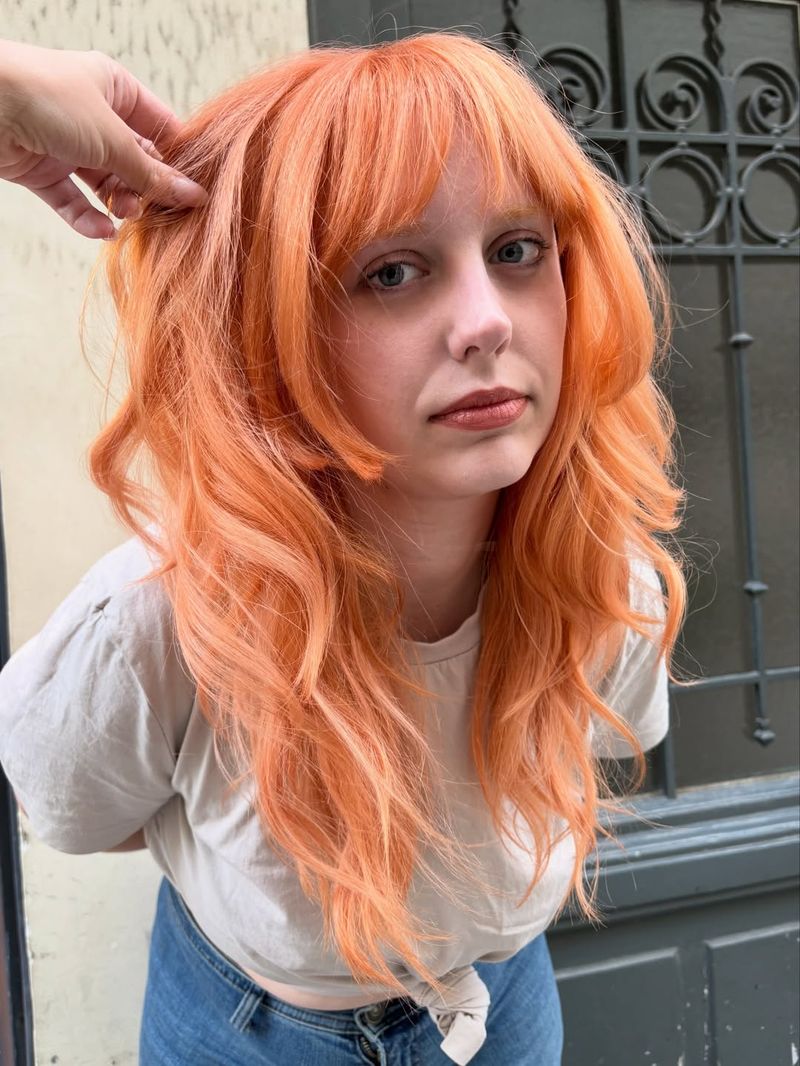 40. Bright Tangerine Shag with Blunt Bangs