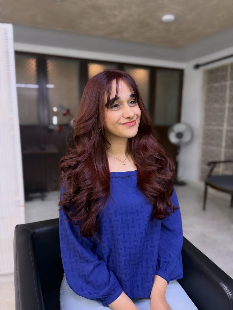 30. Burgundy Bouncy Blowout with Wispy Bangs