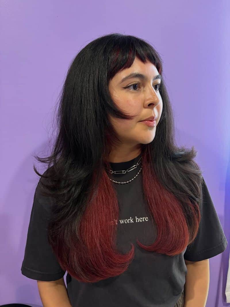 26. Burgundy Peaked Bangs and Layers