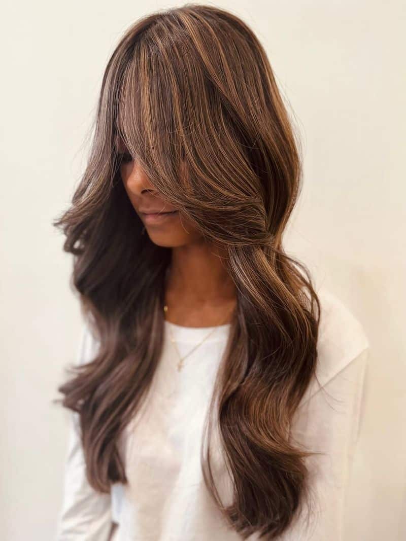 24. Caramel Highlights with Long Curtain Bangs