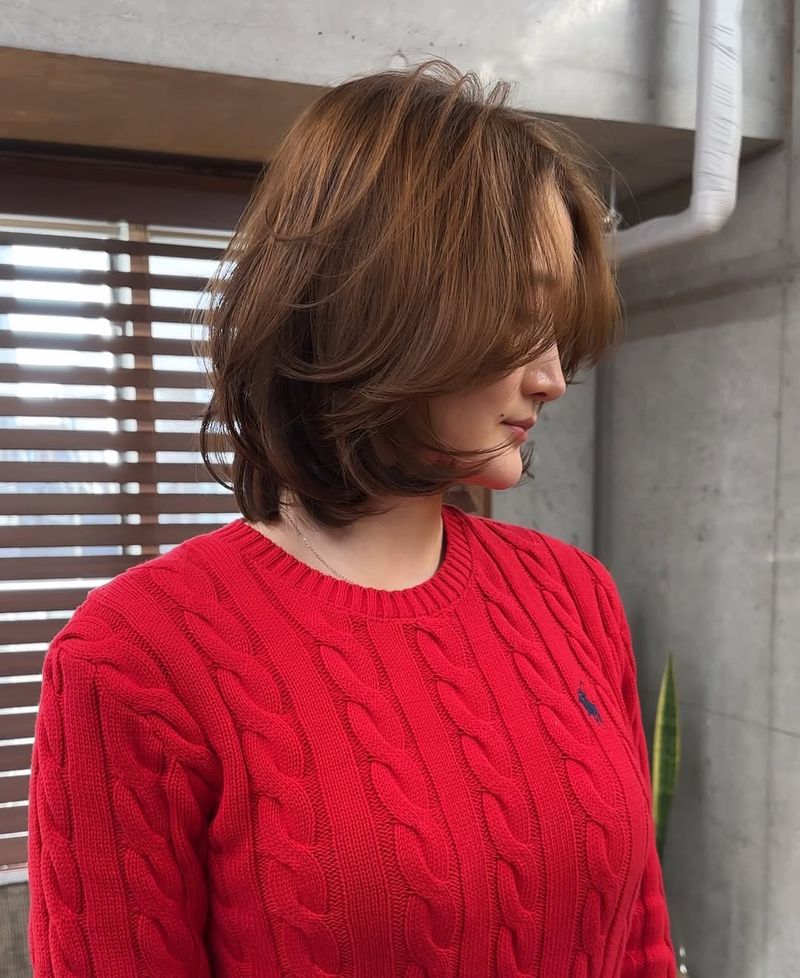 27. Caramel Layered Bob with Long Fringe