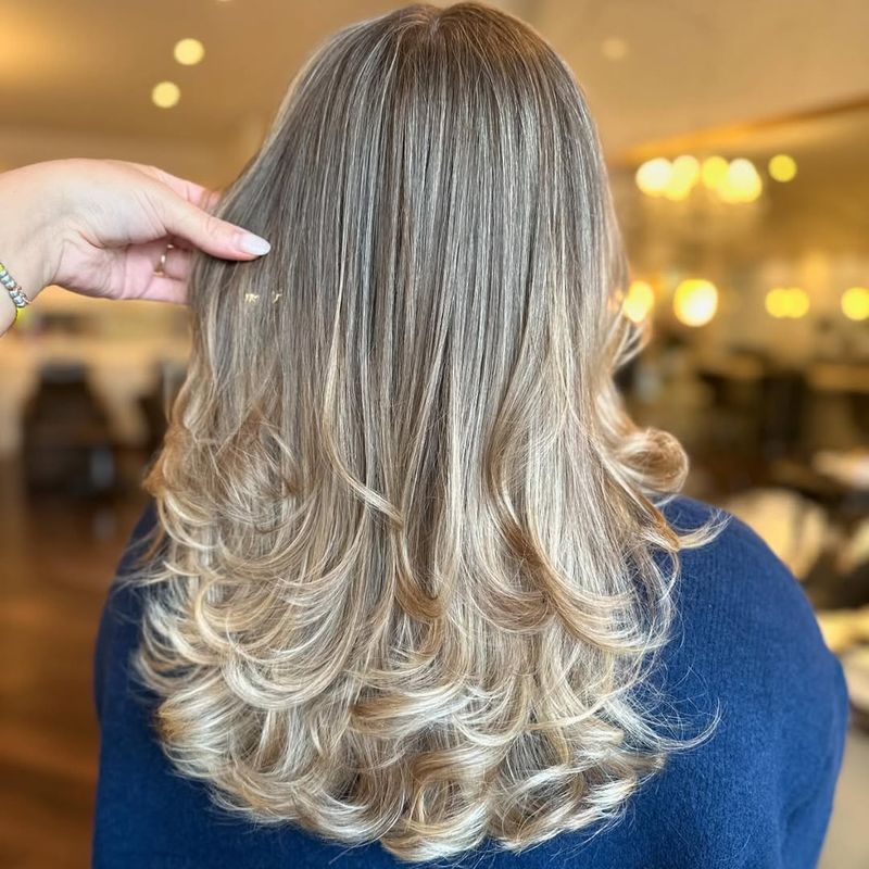 14. Cascading Blonde Feathered Layers