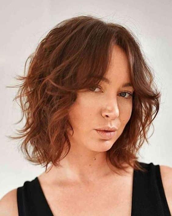 45. Copper Shaggy Bob with Curtain Bangs