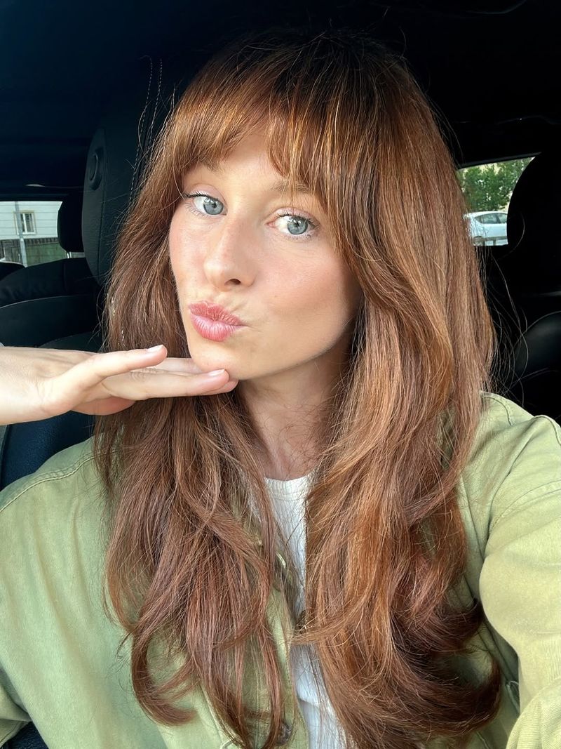 25. Coppery Layers with Heavy Bangs