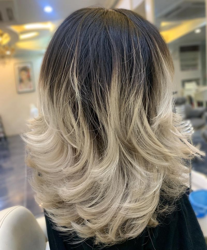 11. Dark Roots and Platinum Feathered Ends