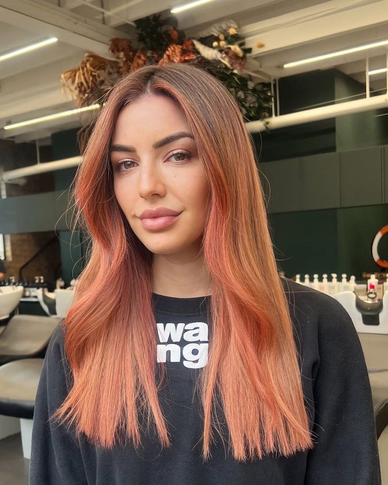 3. Dark Roots with Coral Face-Framing Highlights