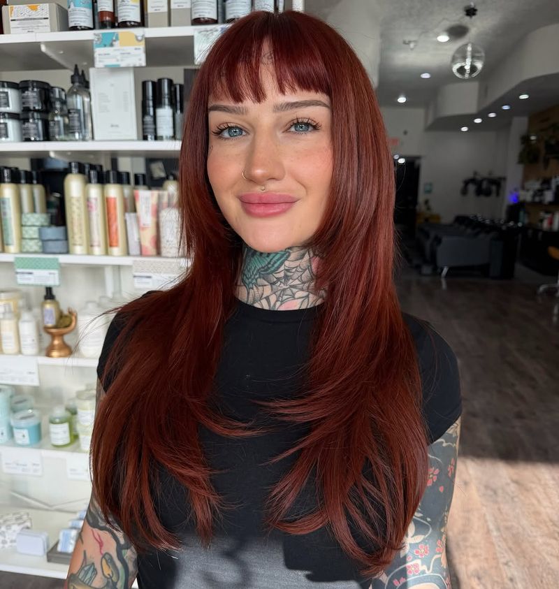 28. Deep Auburn Layers with Wispy Bangs