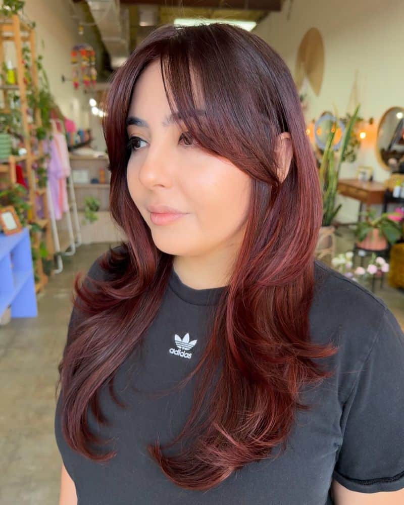30. Deep Burgundy Layers with Curtain Bangs