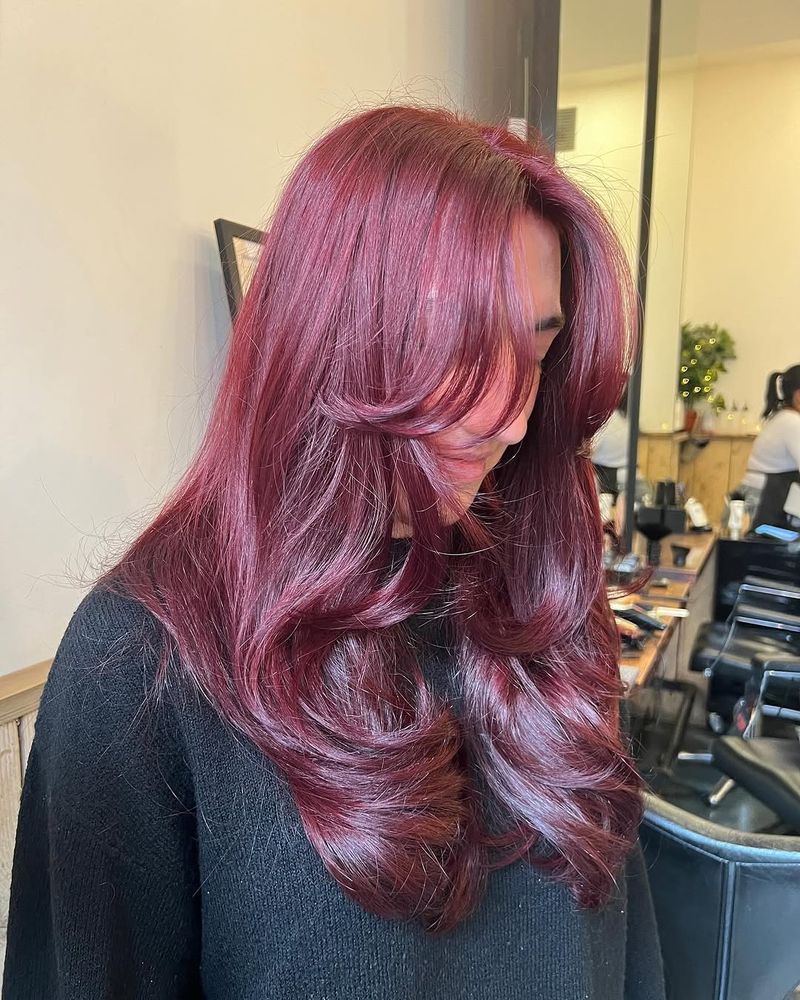 5. Deep Burgundy Layers with Curtain Bangs