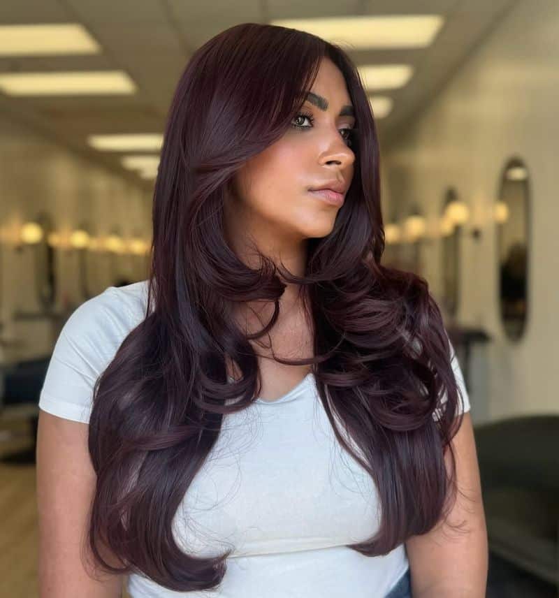 4. Deep Burgundy Layers with Side-Swept Bangs
