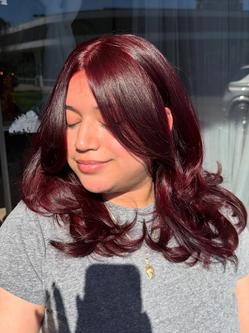 19. Deep Cherry Layers with Curtain Bangs