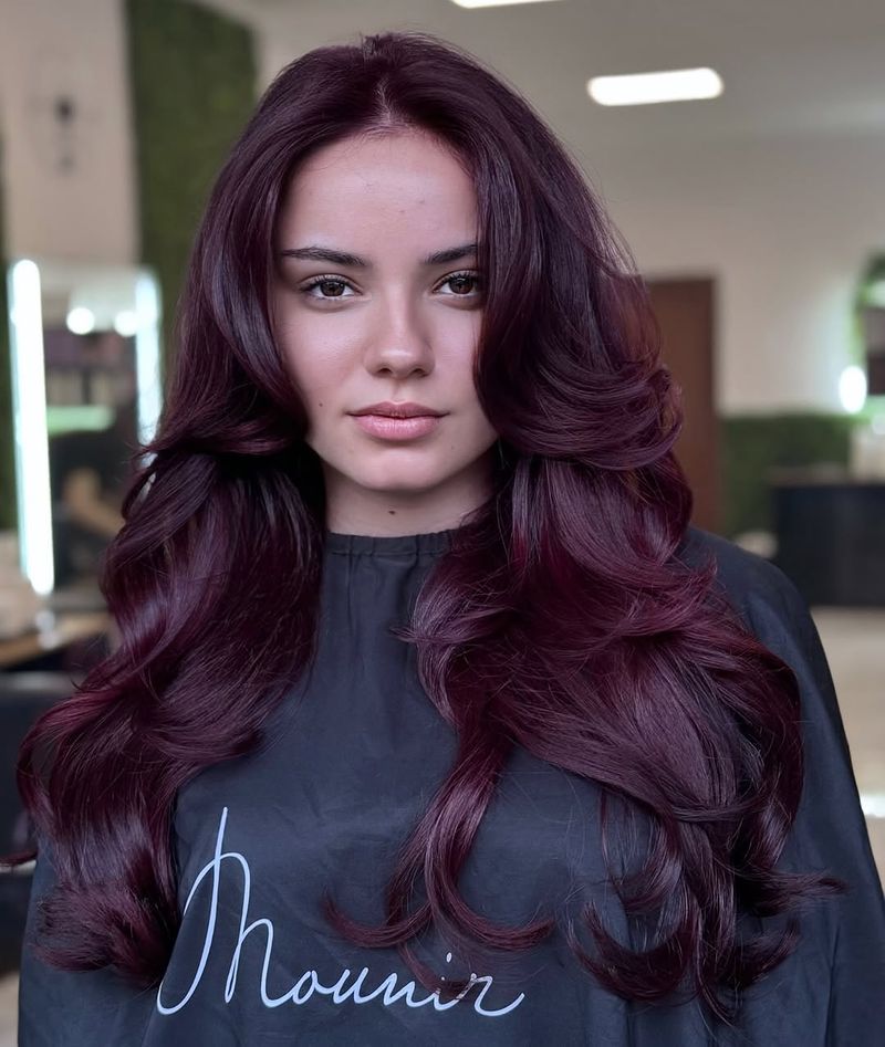 6. Deep Plum Layers with Curtain Bangs