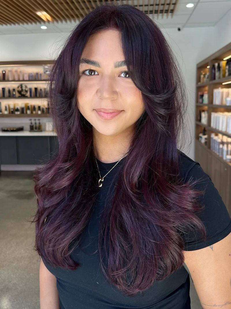 22. Deep Plum Layers with Curtain Bangs