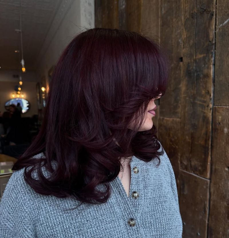 23. Deep Plum Layers with Curtain Bangs
