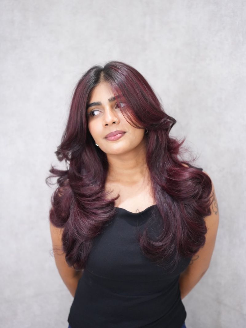 24. Deep Plum Layers with Face-Framing Blowout