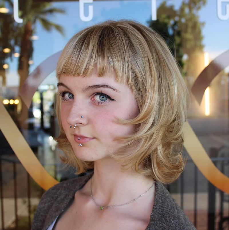 22. Feathered Blonde Bob with Baby Bangs