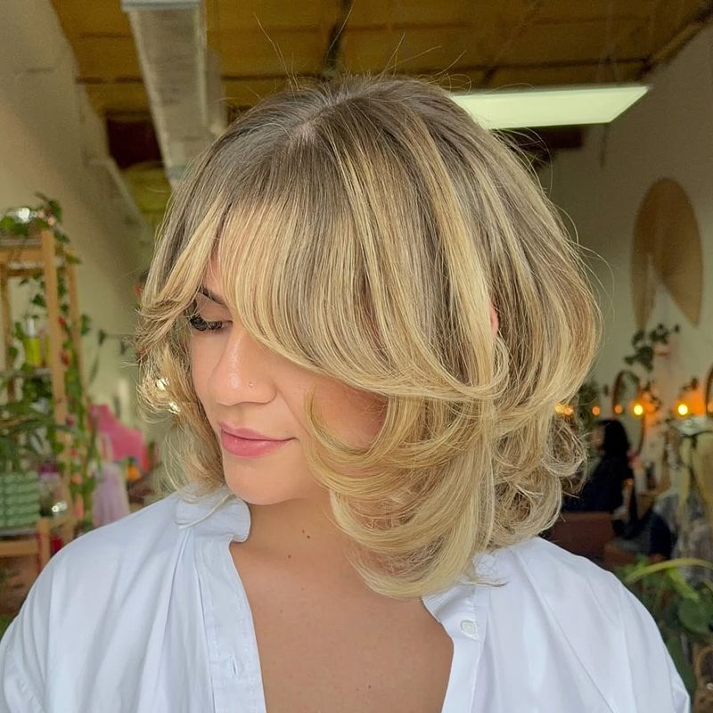 3. Feathered Curtain Bangs Bob