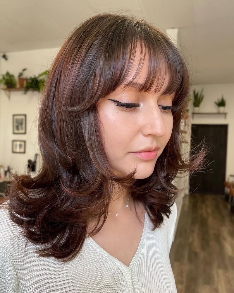 40. Feathered Layers with Soft Brow-Skimming Fringe