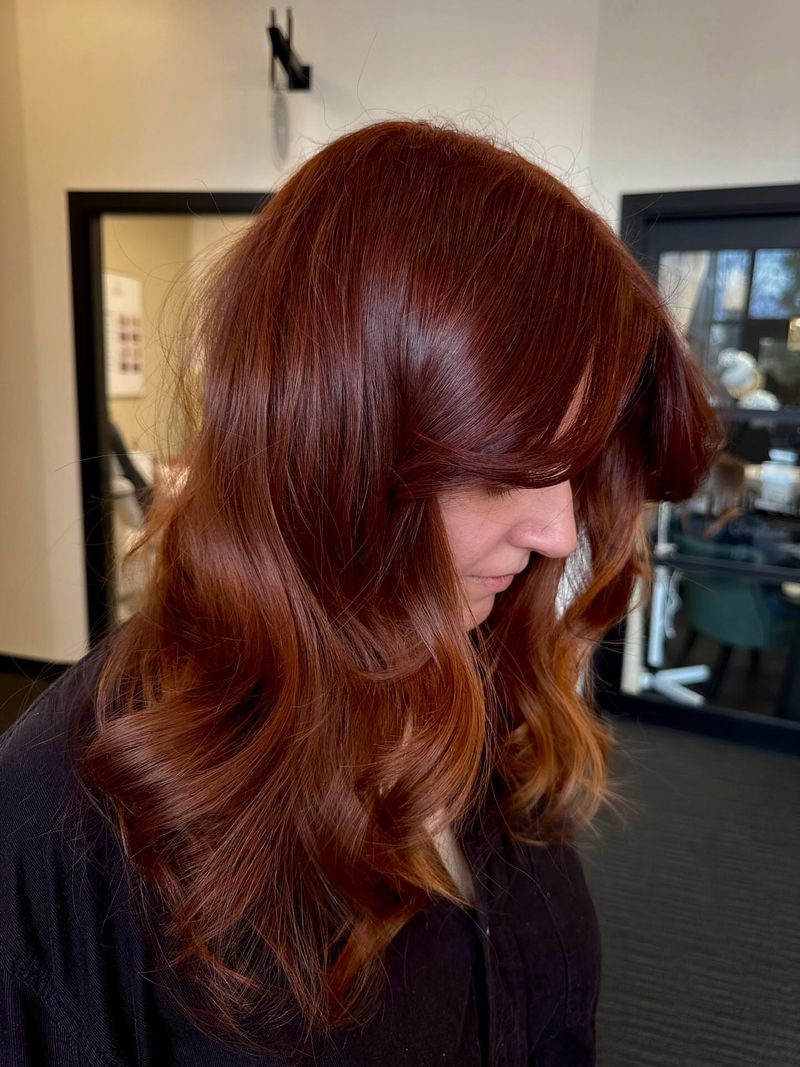 2. Glossy Auburn Melt with Curtain Bangs