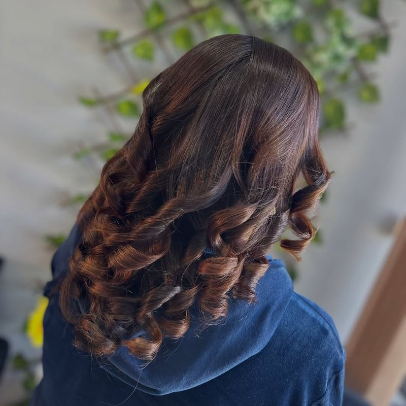 35. Glossy Curls with Chestnut Undertones