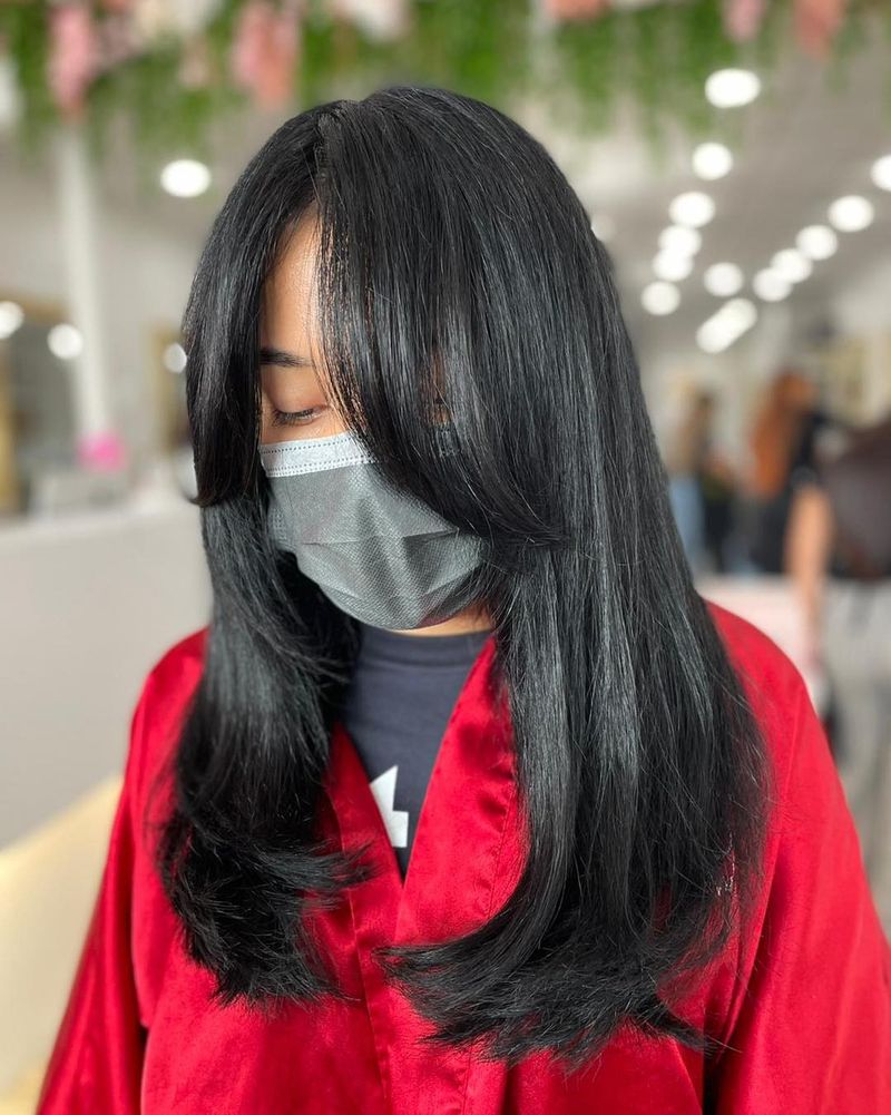 18. Glossy Layers with Soft Curtain Bangs