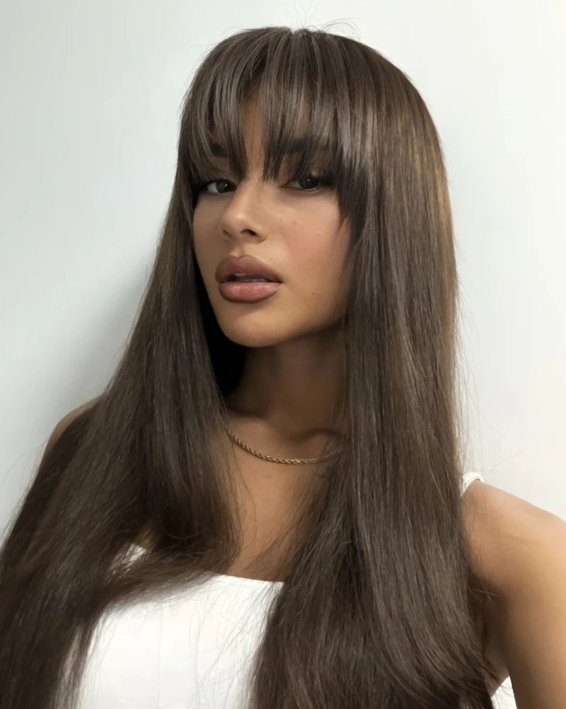 12. Glossy Long Layered Cut with Straight-Across Fringe