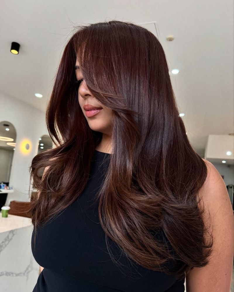 32. Glossy Long Layers with Sweeping Side Fringe
