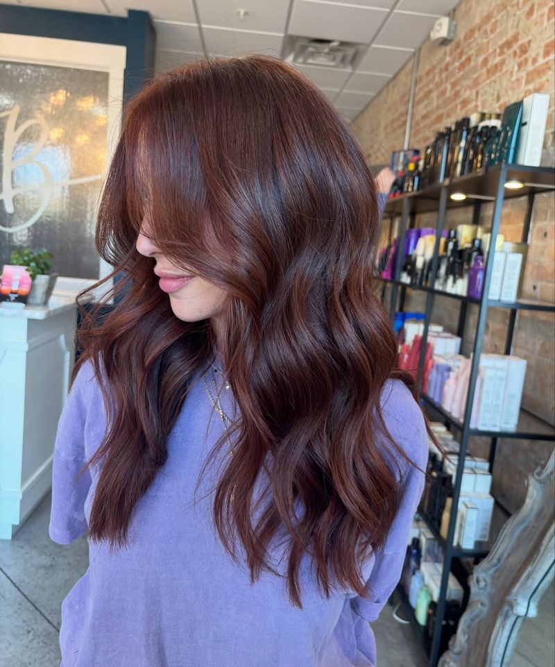 17. Glossy Mahogany Waves with Curtain Bangs